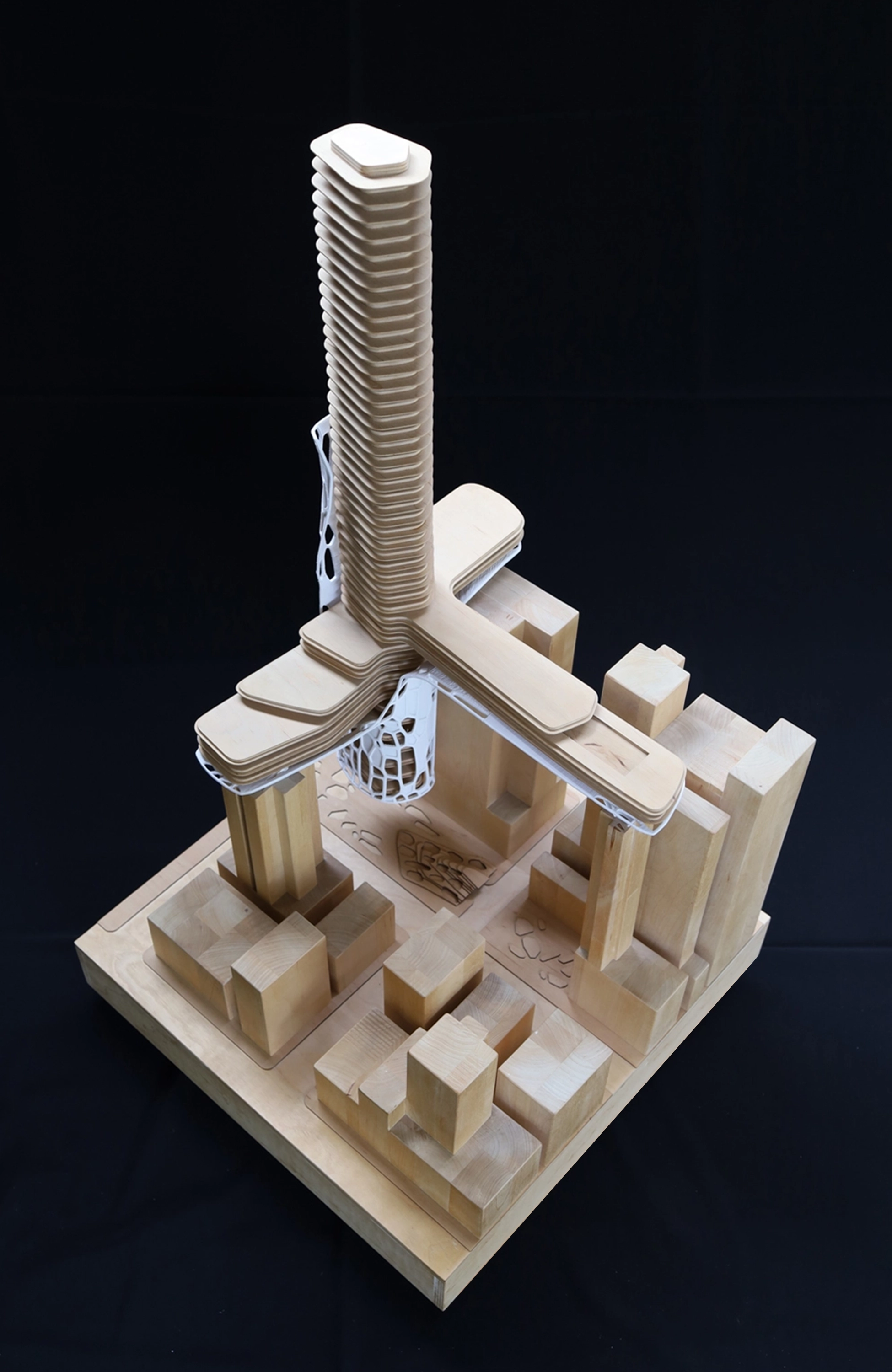 Plywood physical model of the Red Light Hotel, its stacked tower and cantilevered decks rising over the surrounding city blocks.